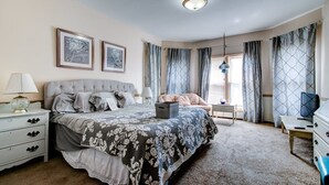 A bedroom with a bed, bedside tables, a desk, and a chair. - Spacious 7-bedroom, 4 bathroom house with WiFi and new HVAC in wonderful Wichita (Wichita)
