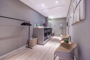 A laundry room with a washing machine, dryer, and a drying rack. - JIN YOTEL(South Second Ring & South Shiyangqiao Road, Hohhot) (Hohhot)