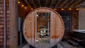 A wooden sauna with a glass door, a bench outside, and a wooden exterior. - Après Chalet|Ski|Luxury|Sauna|HotTub|Firepit|Disco (Windham)