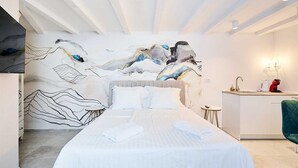 A modern bedroom with a bed, a desk, and a chair. - Karma Suites by Dominium Studio ground floor (Dubrovnik)