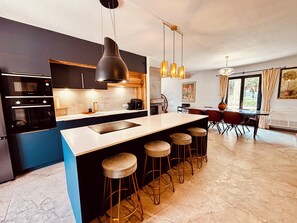 Enjoy meals in the kitchen with an oven and dining area, or relax by the fireplace.