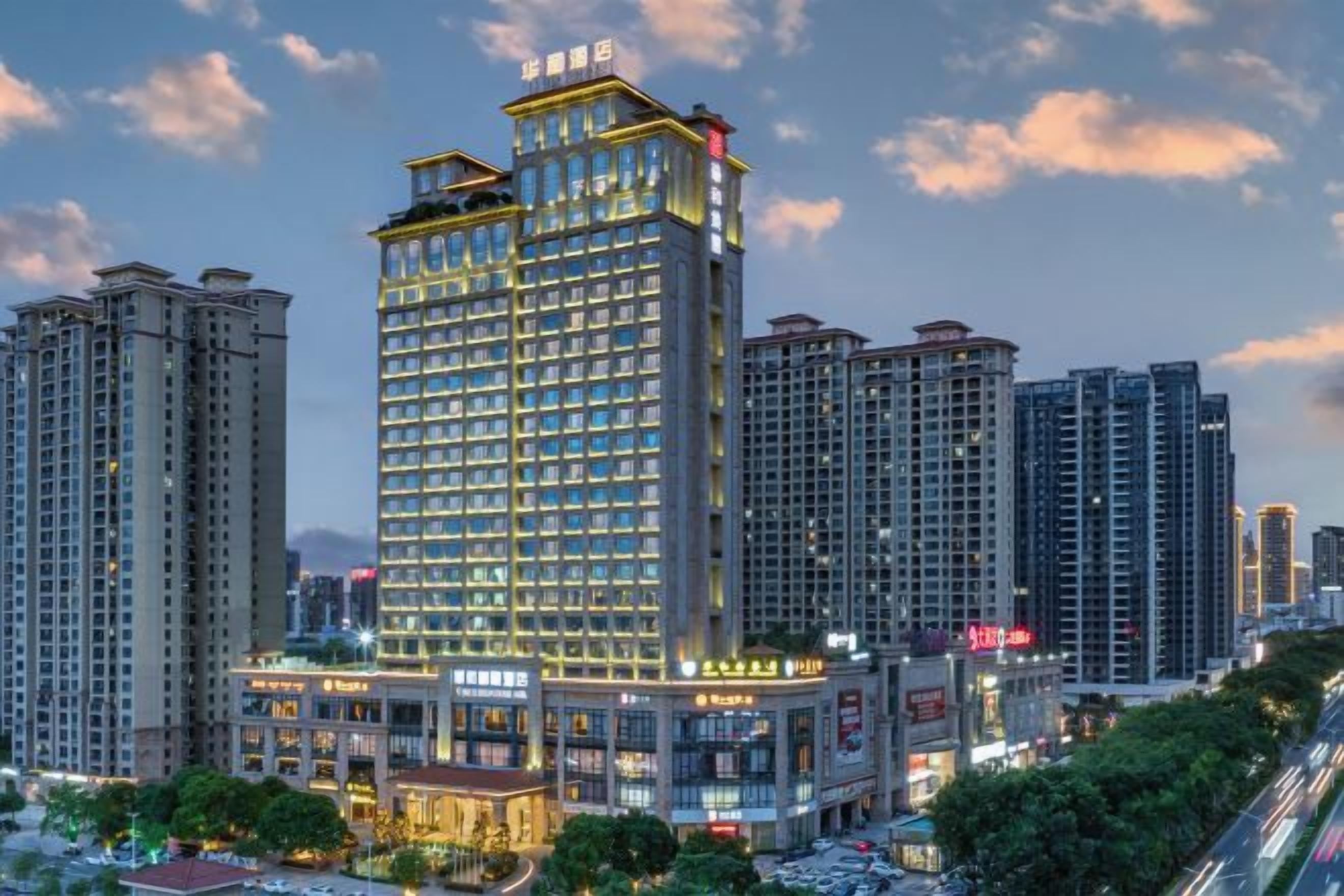 A high-rise hotel with multiple floors, large windows, and a prominent entrance.