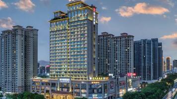 A high-rise hotel with multiple floors, large windows, and a prominent entrance.