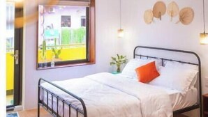A bedroom with a bed, bedside tables, a window, and wall decorations. - ZY 4. Little Saigon Balcony -- Riverside Vibrant D1 (Ho Chi Minh)