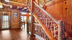 A wooden interior with a staircase and a door leading outside. - Authentic log cabin with a spectacular view !  Enjoy the seclusion and sunsets (Townsend)