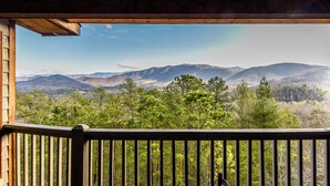 A wooden deck with a view of a mountainous landscape.