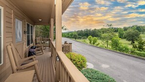 A wooden porch with a view of a road and greenery. - This home is located on a beautiful golf course community and has a view (Townsend)