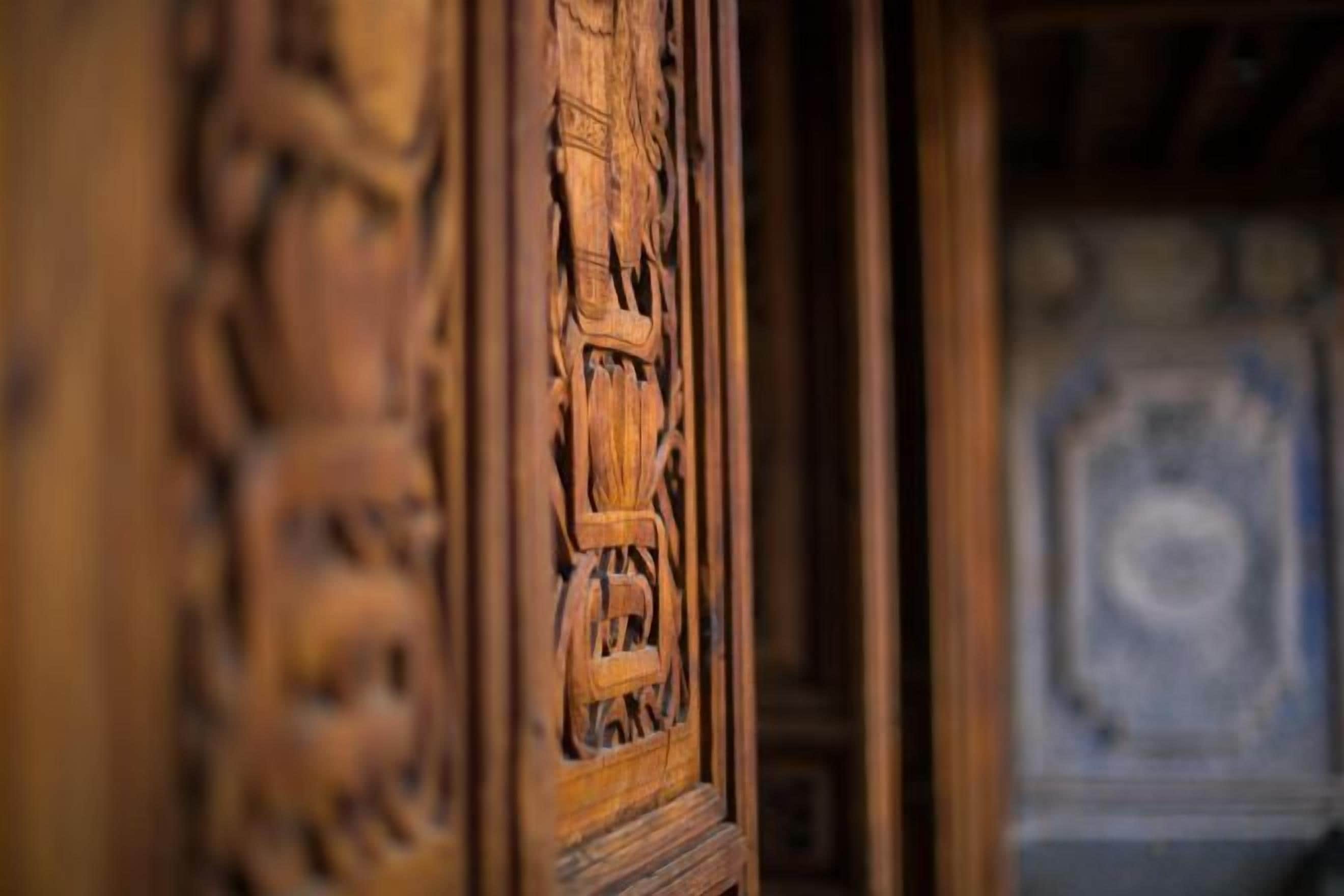 A close-up of a wooden door with intricate carvings.