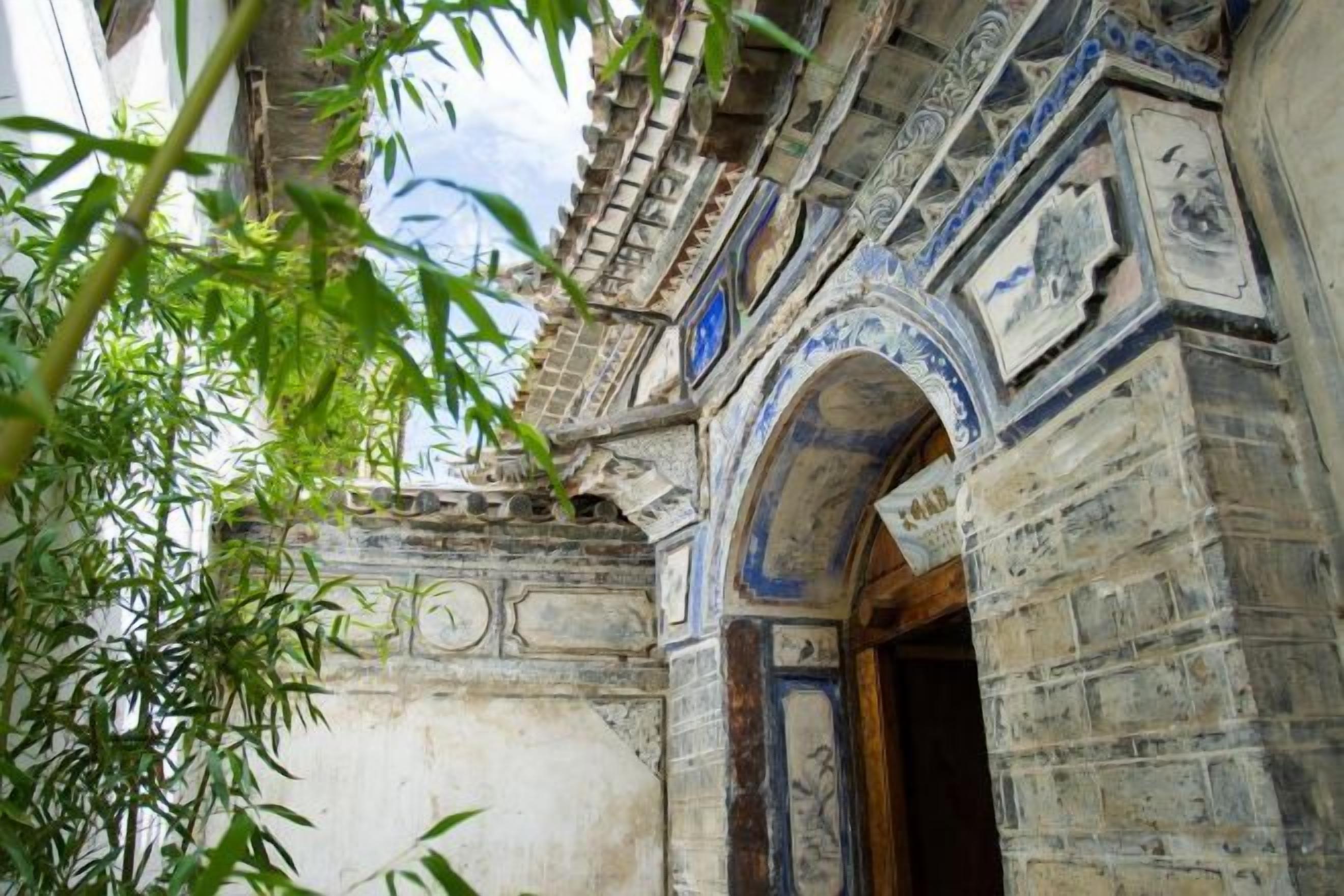An architectural doorway with intricate carvings and a traditional design.