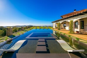 A swimming pool with a clear view of the mountains in the background. - Malibu Sky View Estate (Malibu)