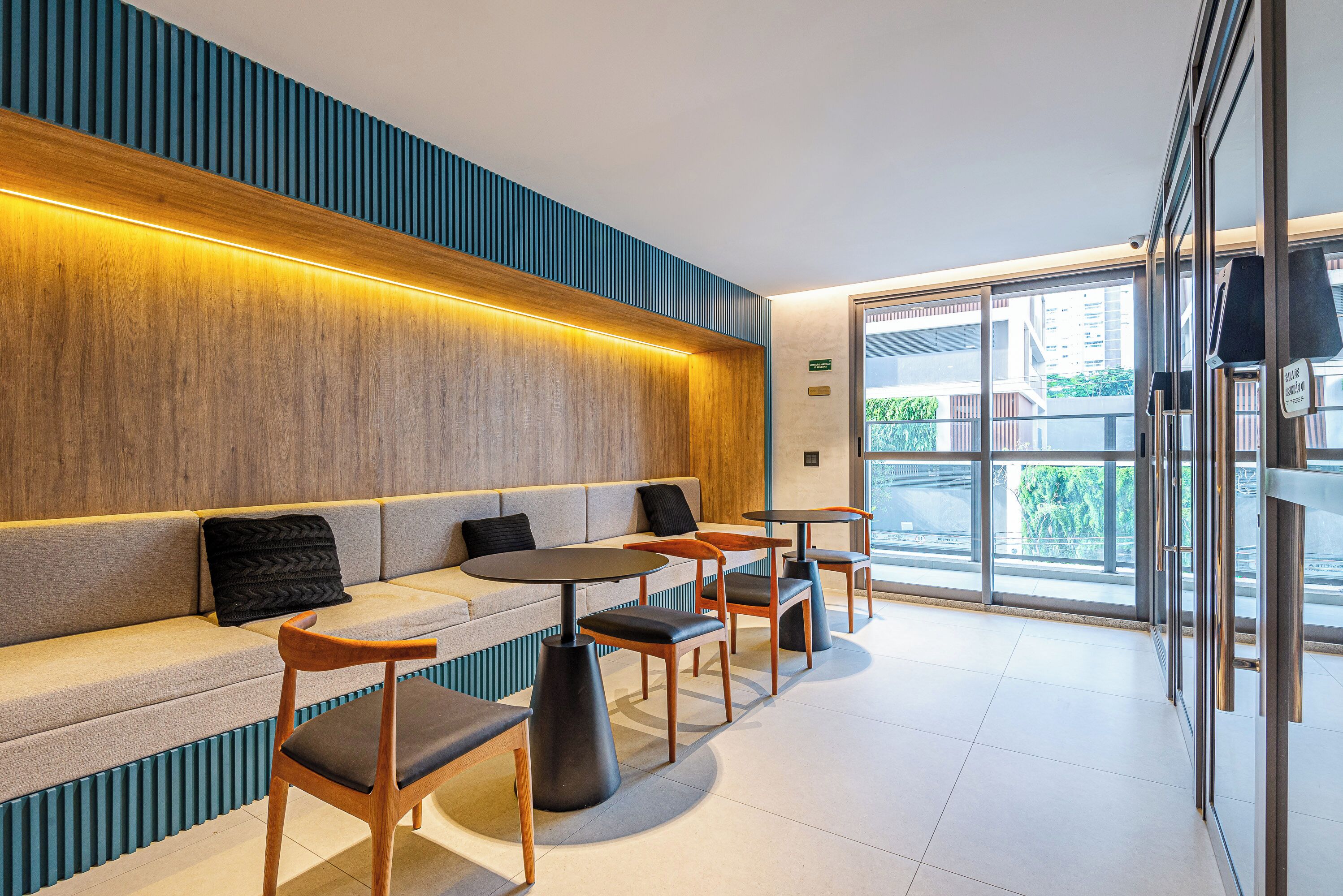 A modern interior with a sofa, chairs, and tables arranged for seating.