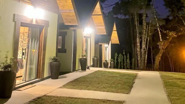A modern house with a sloped roof and a well-lit entrance.
