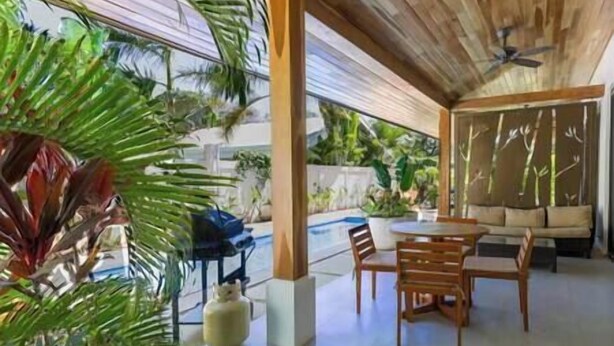 A covered outdoor area with a pool, wooden furniture, and tropical plants. - Bright and Tropical Casa Mar, Playa Pelada, Nosara (NICOYA)