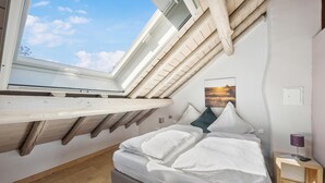 A bedroom with a skylight, a bed, a bedside table, and a lamp. - Amazing home in Feuerscheid (Feuerscheid)