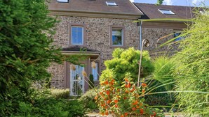 A stone house with a sloped roof, two windows, and a small porch. - Amazing home in Feuerscheid (Feuerscheid)