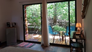 A room with a sliding glass door leading to an outdoor deck with chairs and a table. - Lodge for 6 people. Comprising 3 bungalows with swimming pool.   (Pinilla)