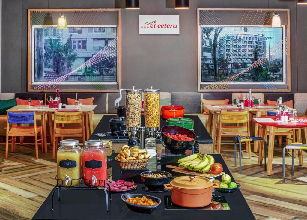 A buffet setup with various food items and condiments.