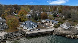 Un barrio residencial con casas, un muelle y un litoral rocoso.