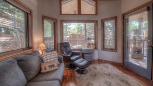 A cozy living room with a gray sofa, a leather recliner, and a patterned rug. - Perfect Getaway Cabin w/ Nearby Hike/Bike Trails (Breckenridge)