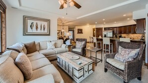 A spacious living room with a sofa, armchairs, a coffee table, and a ceiling fan. - Best Mtn View-Ski In/Ski Out & Gondola to Downtown (Breckenridge)