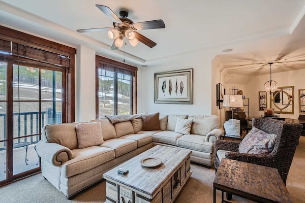 Curl up in the cozy living room & stream your favorites by the fireplace