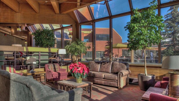 A spacious interior with large windows, a wooden ceiling, and multiple seating areas. - Tons of Amenities! | Ski In Ski Out! (Breckenridge)