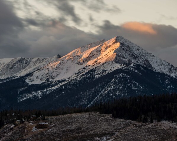 A mountain landscape with snow-covered peaks and a small settlement at its base. - Cozy 1BR Near Trails w/ Shuttle to Slopes and Town (Breckenridge)