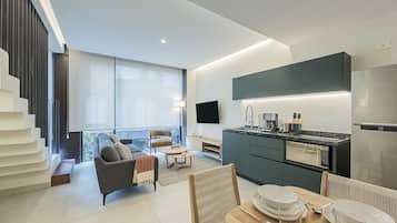 A modern apartment with a living area, kitchen, and dining space.