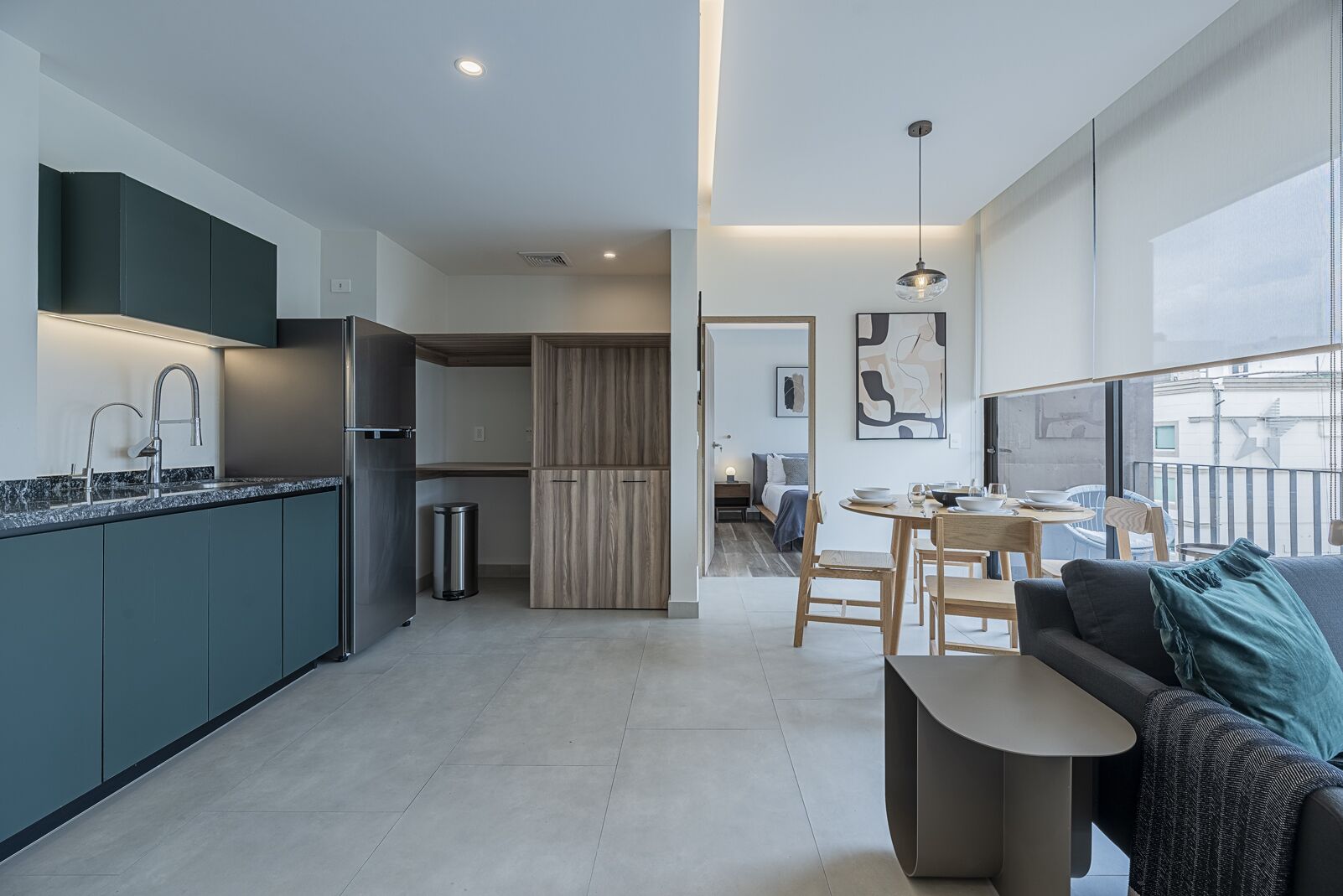 A modern apartment with a kitchen, dining area, and living room.