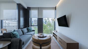 Deluxe Apartment, 1 Bedroom, Balcony | Living area | 55-inch Smart TV with digital channels