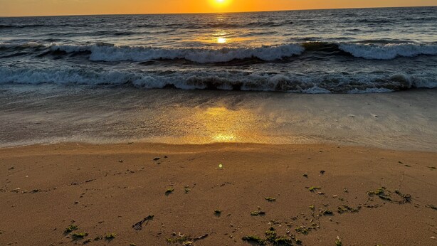 A beach with waves and a sunset. - Remodeled 3-bedroom condo in Marina walking distance to beach; STR25-000040 (Marina)