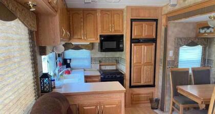 Lake shore queen bed trailer, tiki torches, & tent space for extra guest