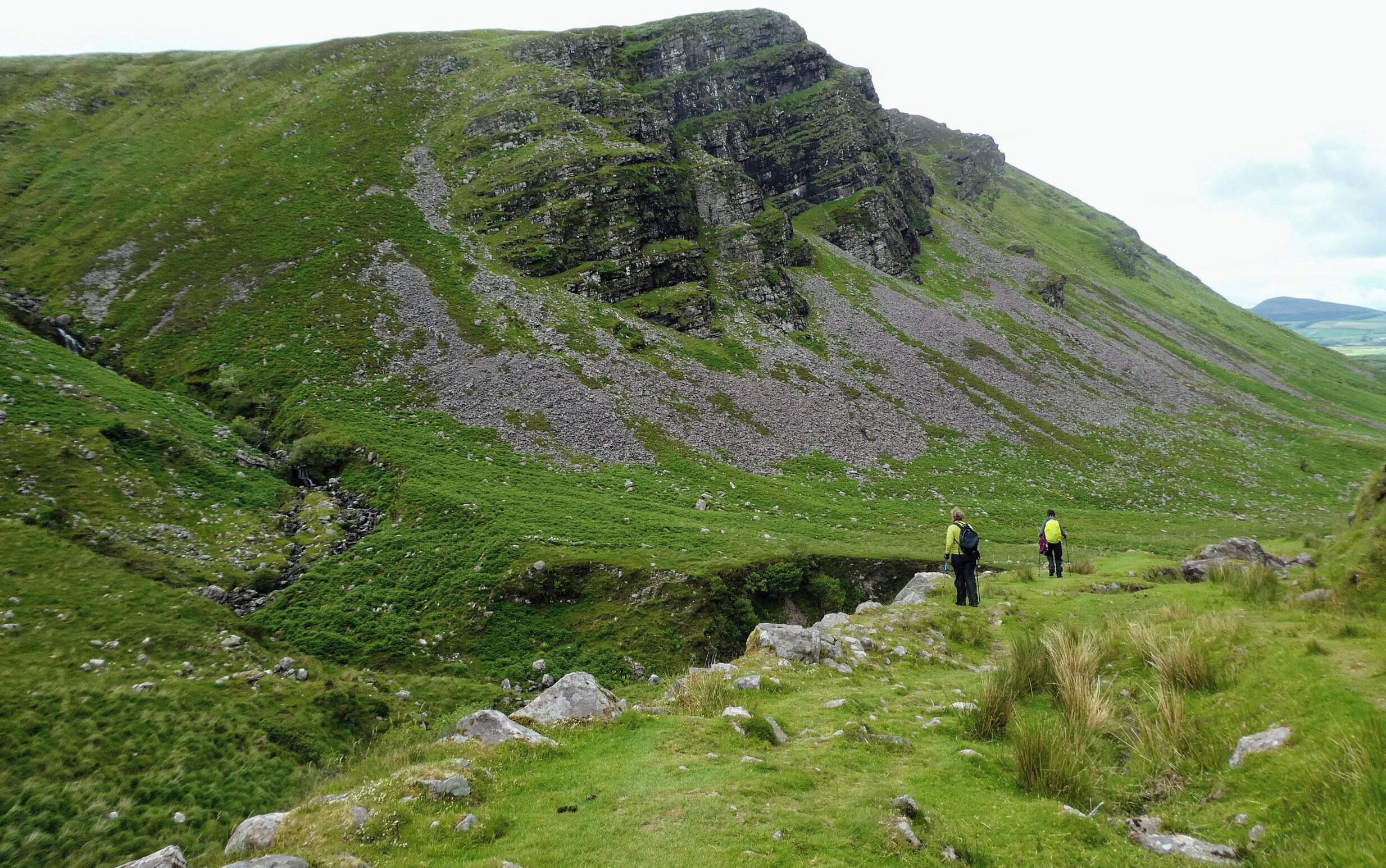 A mountainous landscape with hikers.