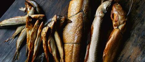 A variety of dried fish displayed on a wooden surface.