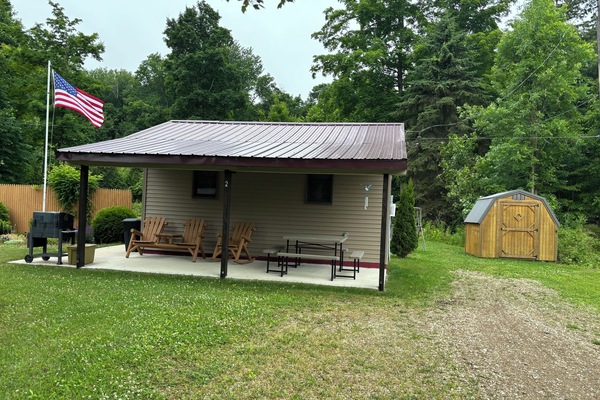 Private covered porch with seating, grill and yard games to enjoy!