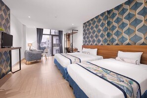 A hotel room with two beds, a TV, a desk, and a view of the city. - Essenza Hotel (Da Nang)
