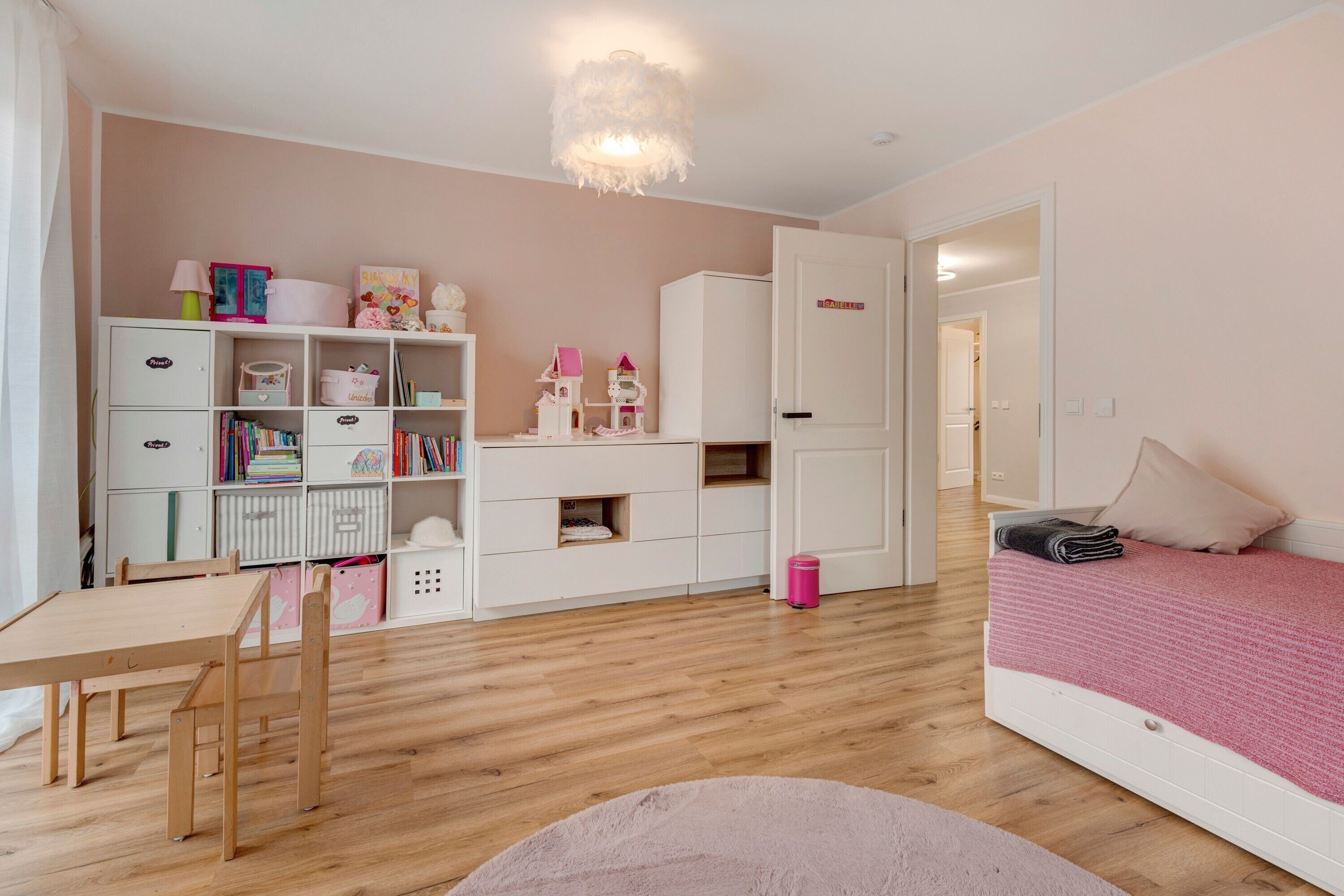A bedroom with a bed, a desk, a chair, a bookshelf, and a wardrobe.