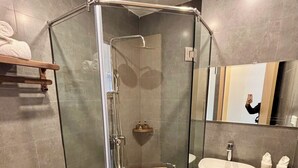 A modern bathroom with a glass-enclosed shower, a white sink, and a toilet. - Truong Giang Boutique Hotel (Thao Nguyen)