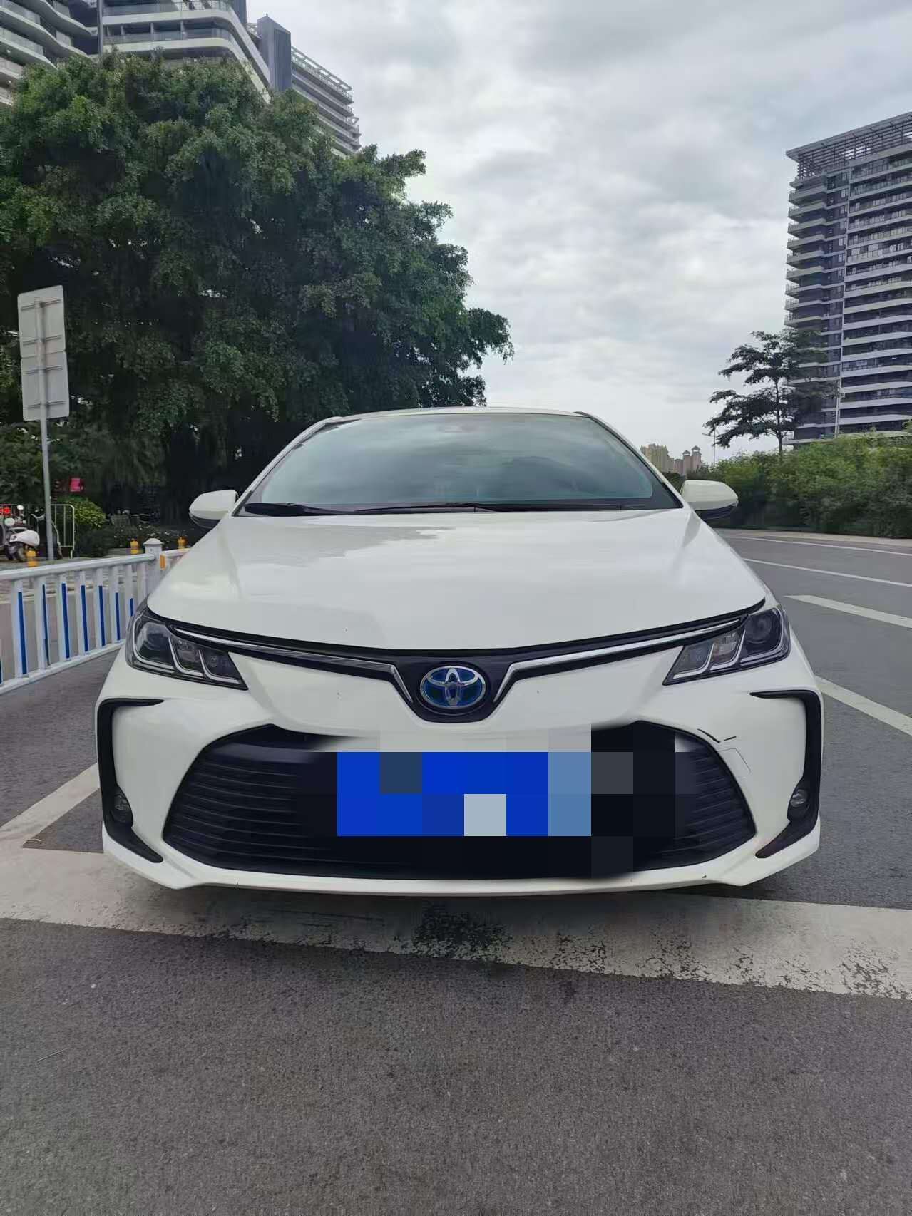 A white car parked on a city street.