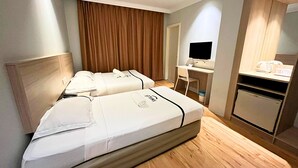 A hotel room with two beds, a desk with a computer, and a kitchenette. - Sky Hotel Chow Kit PWTC (Kuala Lumpur)