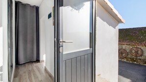 A modern entrance with a sliding glass door, a metal handle, and a keyhole.