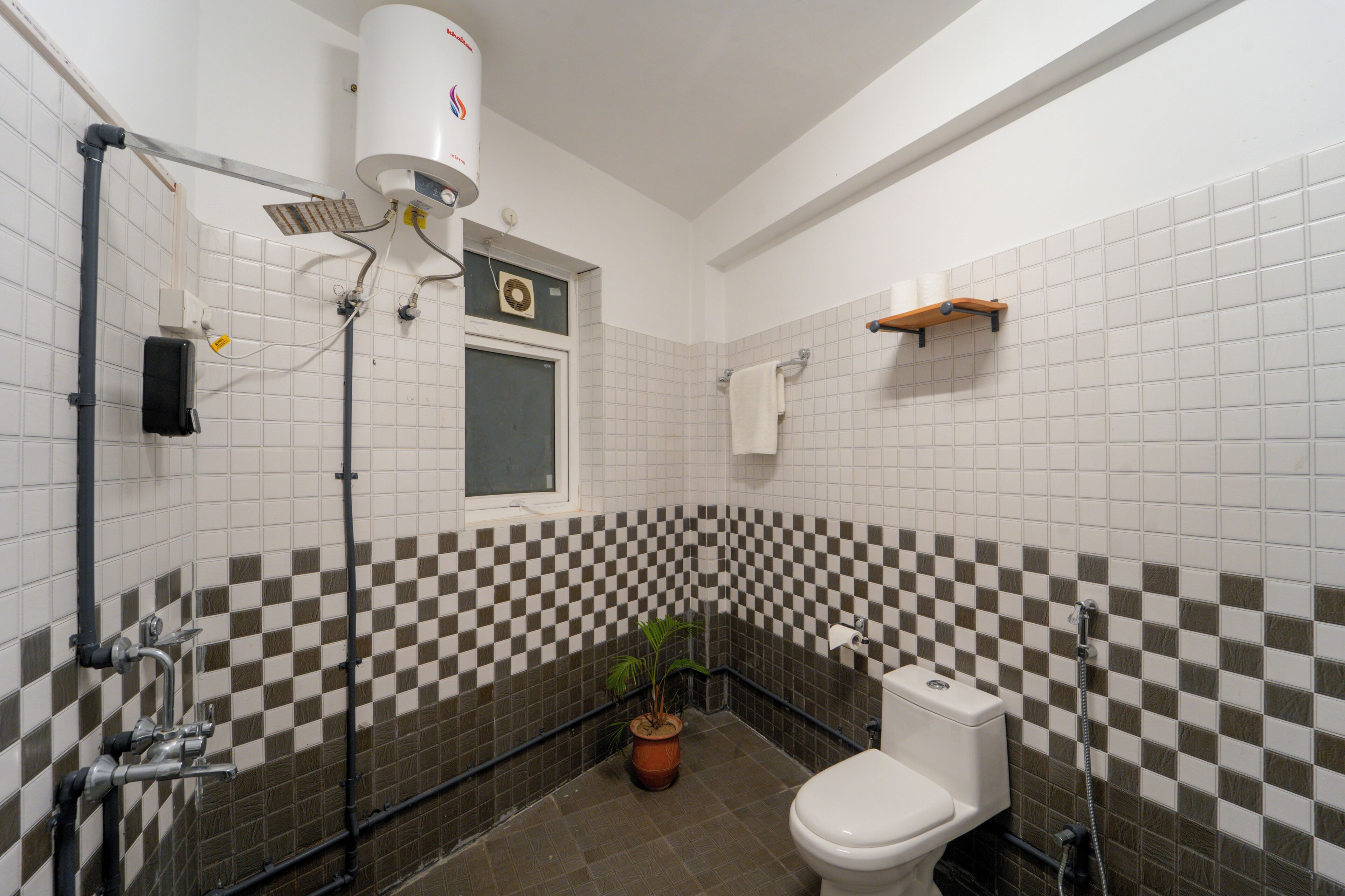 A bathroom with a toilet, sink, and shower.