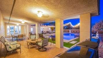 Relax by the pool in this inviting patio area, complete with lounge chairs and a dining table.