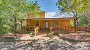 A wooden cabin with a porch, steps leading to the door, and potted plants. - Hot Springs Cabin w/ Deck + Mountain Views! (Hot Springs)