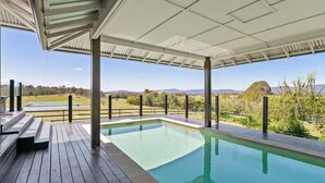 A pool area with a view of a natural landscape. - Mountain Majesty with Poolside: Relaxing Getaway (Tamborine)