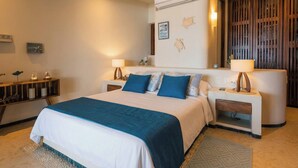 A modern bedroom with a large bed, bedside tables, a wall-mounted air conditioner, and a decorative wall panel.