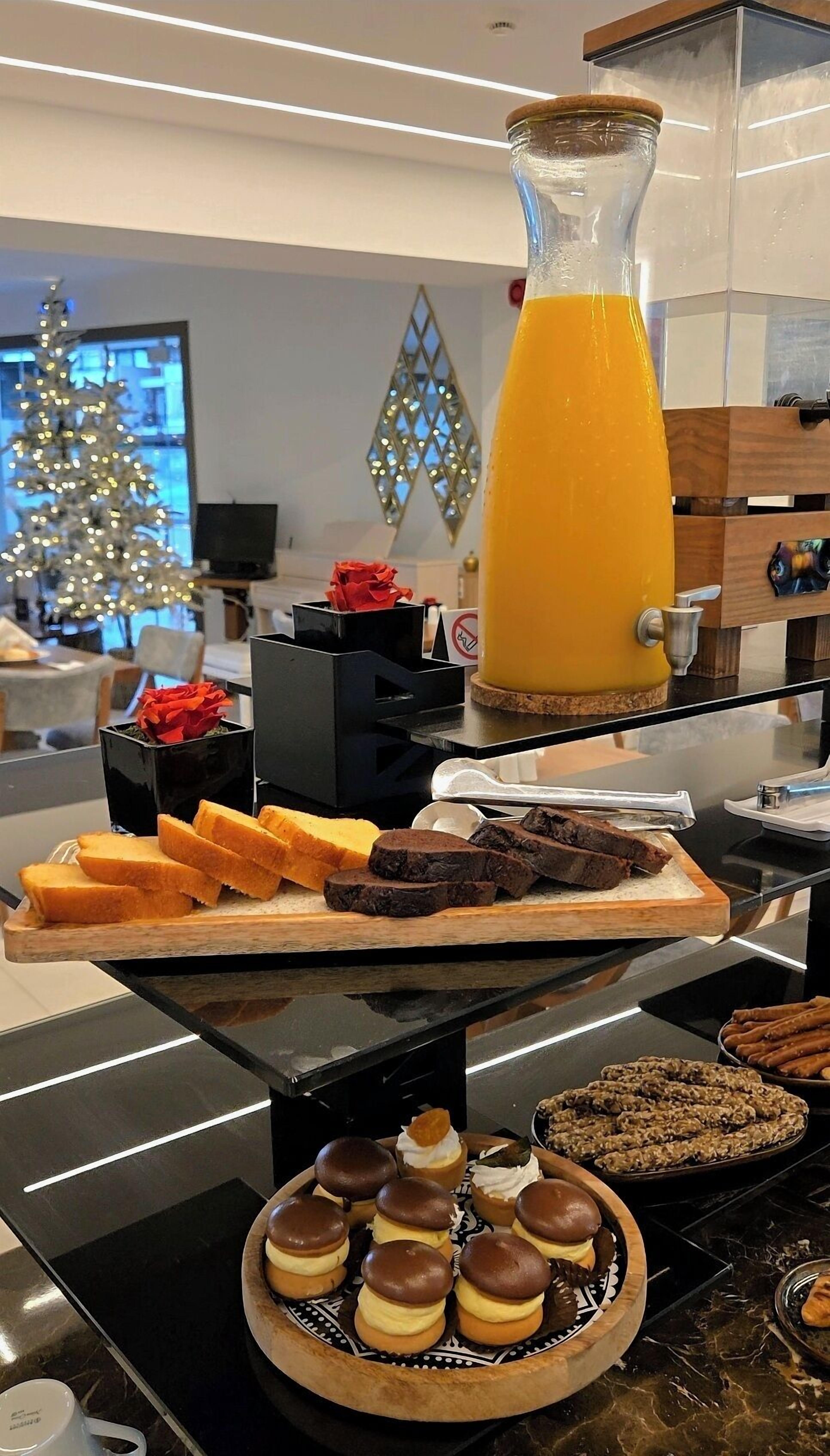 A buffet with various food items including bread, meat, and desserts.