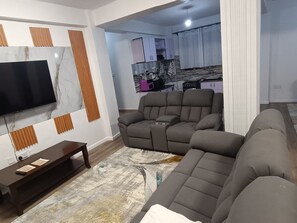Standard Apartment | Living area | 40-inch TV with digital channels