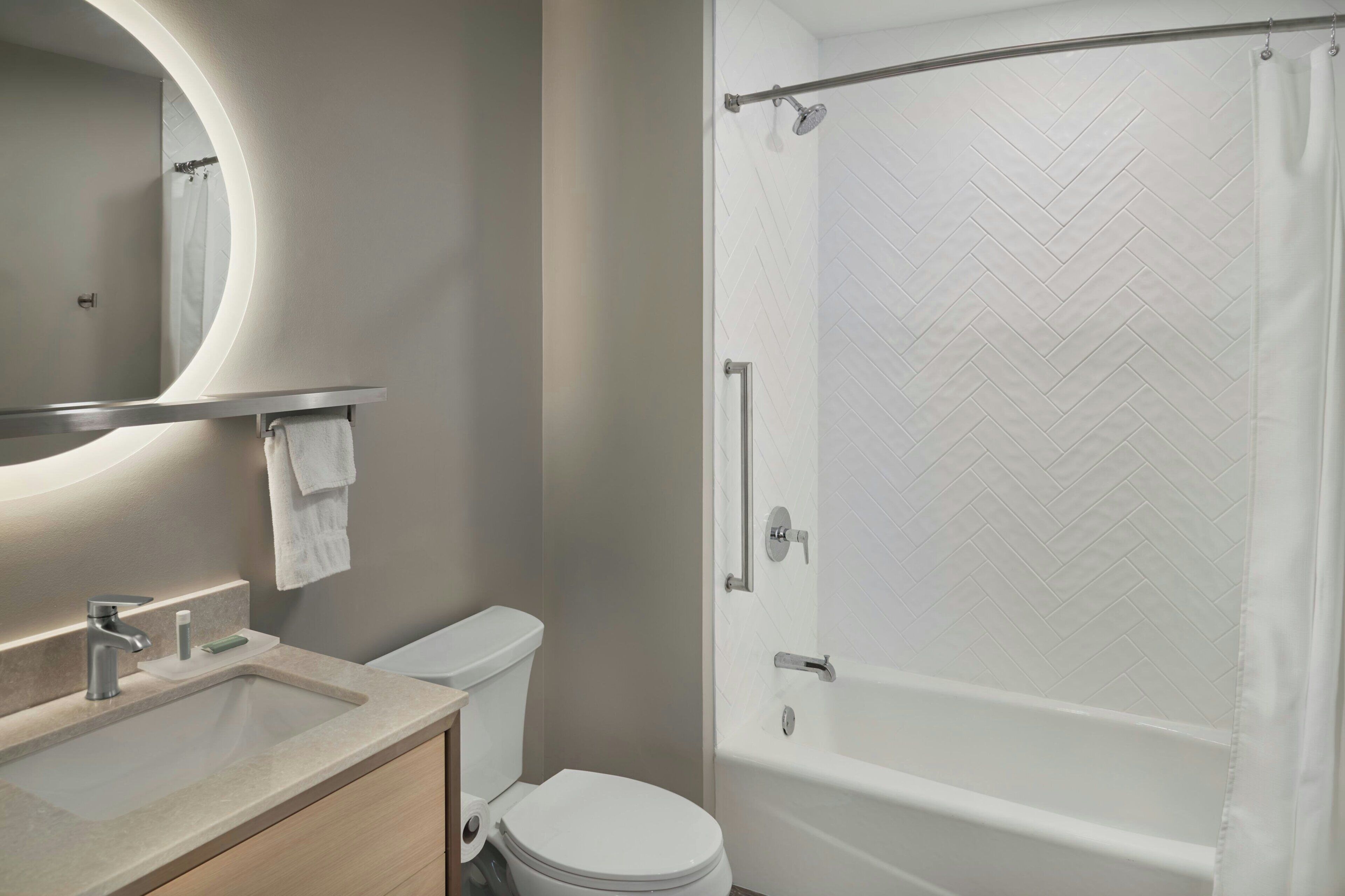 A bathroom with a sink, toilet, and a shower with a glass door.