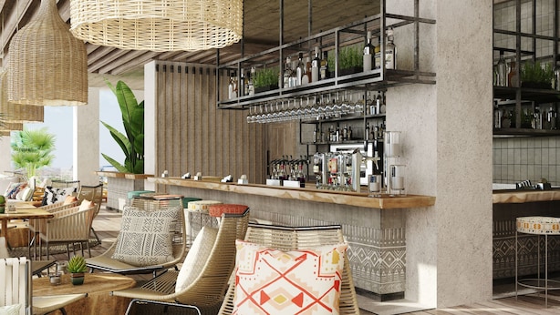 A modern bar area with wicker furniture, a bar counter, and shelves with bottles and glasses. - Four Points By Sheraton Dakar Diamniadio (Diamniadio)